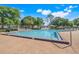 Community pool with lounge chairs and clear blue water on a sunny day at 14305 Pine Cone Trl, Clermont, FL 34711