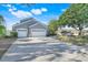 Charming two-story home featuring a three-car garage and a large driveway at 14305 Pine Cone Trl, Clermont, FL 34711