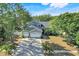 Charming two-story home featuring a three-car garage, arched entry and lush, mature landscaping at 14305 Pine Cone Trl, Clermont, FL 34711