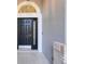 A close-up of the front door shows a tiled entry and decorative window above the door at 14305 Pine Cone Trl, Clermont, FL 34711