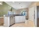 Kitchen with granite countertops, stainless steel appliances, white cabinets, and ample counter space at 14305 Pine Cone Trl, Clermont, FL 34711