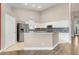Modern kitchen features white cabinets, stainless steel appliances, granite countertops, and kitchen island at 14305 Pine Cone Trl, Clermont, FL 34711