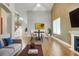 Cozy living room with wood floors, fireplace, and views into the dining room at 14305 Pine Cone Trl, Clermont, FL 34711