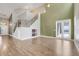 Spacious living room features staircase with iron spindles, high ceilings and plenty of natural light at 14305 Pine Cone Trl, Clermont, FL 34711