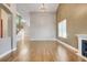 Spacious living room features high ceilings, an elegant chandelier, and gleaming hardwood floors at 14305 Pine Cone Trl, Clermont, FL 34711