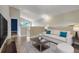 Cozy living room with neutral tones, hardwood floors, comfortable seating, and natural light at 14305 Pine Cone Trl, Clermont, FL 34711