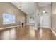 Bright living room featuring high ceilings, wood floors, a fireplace, and large windows at 14305 Pine Cone Trl, Clermont, FL 34711