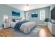 Light and airy main bedroom with ensuite, calming blue palette and stylish decor at 14305 Pine Cone Trl, Clermont, FL 34711