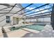 The screened-in pool and lanai showcase a modern outdoor living space, perfect for relaxation and entertainment at 14305 Pine Cone Trl, Clermont, FL 34711