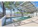 A screened-in pool features clear water and a surrounding deck, offering a relaxing outdoor space at 14305 Pine Cone Trl, Clermont, FL 34711