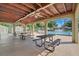 Covered community pool pavilion with picnic tables and view of the pool at 14305 Pine Cone Trl, Clermont, FL 34711
