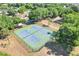 Aerial view of two community tennis courts with a green and blue playing surface at 14305 Pine Cone Trl, Clermont, FL 34711