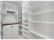 Walk-in closet provides custom shelving and cabinet space, creating perfect storage solution at 14305 Pine Cone Trl, Clermont, FL 34711