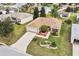 Aerial view of a well-maintained property featuring a beautiful lawn, charming landscaping, and an attractive home exterior at 1526 Blueberry Way, The Villages, FL 32162