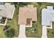 Bird's-eye view of a home with a manicured lawn and landscaping in a peaceful neighborhood setting at 1526 Blueberry Way, The Villages, FL 32162