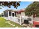 Charming backyard featuring a patio, white picket fence, and well-manicured lawn at 1526 Blueberry Way, The Villages, FL 32162