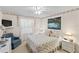 Cozy bedroom featuring floral accents, a soft blue armchair, and comfortable furnishings at 1526 Blueberry Way, The Villages, FL 32162