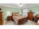 Charming bedroom with a floral-patterned bedspread, wood furnishings, and natural light from a window at 1526 Blueberry Way, The Villages, FL 32162