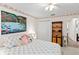Bedroom with floral decor, a view to closet, and a decorative lake painting on the wall at 1526 Blueberry Way, The Villages, FL 32162