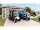 Paver driveway leading to the garage, with two golf carts parked at 1526 Blueberry Way, The Villages, FL 32162