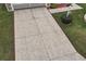 Paver driveway leading to the garage, with a well-manicured lawn at 1526 Blueberry Way, The Villages, FL 32162