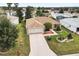 Charming single-story home with a well-manicured lawn, brick accents, and a spacious two-car garage at 1526 Blueberry Way, The Villages, FL 32162