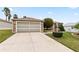 Charming single-story home with a well-maintained lawn and a brick-accented facade at 1526 Blueberry Way, The Villages, FL 32162