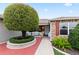 Charming front porch with brick accents, a decorative tree, and a cozy seating area at 1526 Blueberry Way, The Villages, FL 32162