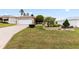 Well-maintained front yard featuring a lush lawn, landscaping, and a charming facade at 1526 Blueberry Way, The Villages, FL 32162