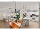 View of the dining area, with kitchen featuring a center island, white cabinetry, and modern appliances at 1526 Blueberry Way, The Villages, FL 32162