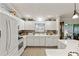 Well-lit kitchen featuring white cabinetry, modern appliances, and a view of the adjacent breakfast nook at 1526 Blueberry Way, The Villages, FL 32162