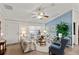 Cozy living room with comfortable floral seating, neutral walls, and a view of the front door at 1526 Blueberry Way, The Villages, FL 32162