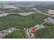 Aerial view shows the neighborhood and surroundings near Sandy Ridge Drive and Old Lake Wilson Road at 156 Ridgebrook Ct, Davenport, FL 33896