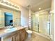 Bathroom with vanity, toilet, and walk-in shower with sliding glass door at 156 Ridgebrook Ct, Davenport, FL 33896