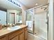 Bright bathroom with a glass-enclosed shower, vanity, and tile flooring at 156 Ridgebrook Ct, Davenport, FL 33896