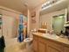 Bright bathroom featuring a shower-tub combo and ample counter space at 156 Ridgebrook Ct, Davenport, FL 33896