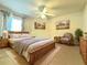 Comfortable bedroom featuring a ceiling fan, neutral walls, and decorative art at 156 Ridgebrook Ct, Davenport, FL 33896