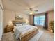 Comfortable bedroom featuring natural light, ceiling fan and hardwood floors at 156 Ridgebrook Ct, Davenport, FL 33896