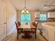 Cozy dining area with a wooden table and a window view to the backyard at 156 Ridgebrook Ct, Davenport, FL 33896