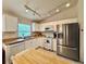Modern kitchen with white cabinets, stainless steel appliances, and ample counter space at 156 Ridgebrook Ct, Davenport, FL 33896