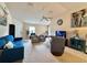 Spacious living room with carpet flooring and comfortable blue seating at 156 Ridgebrook Ct, Davenport, FL 33896