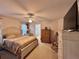Spacious main bedroom featuring a ceiling fan, rocking chair, and ensuite bathroom at 156 Ridgebrook Ct, Davenport, FL 33896