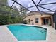 View of the in-ground pool and the rear of the property, featuring a screened enclosure at 156 Ridgebrook Ct, Davenport, FL 33896