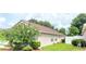 Well manicured backyard featuring bright green lawn and mature shade trees at 15702 Bay Vista Dr, Clermont, FL 34714