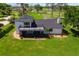 Aerial view of the house showing the large backyard with manicured lawn and screened-in patio and upper level deck at 16047 E Shirley Shores Rd, Tavares, FL 32778