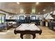 Spacious basement with wood ceiling and floors featuring a pool table and bar at 16047 E Shirley Shores Rd, Tavares, FL 32778