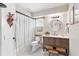 Bathroom with a vanity, round mirror and decorative accents at 16047 E Shirley Shores Rd, Tavares, FL 32778