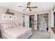 Cozy bedroom with a pink bed and lots of storage space in the closet at 16047 E Shirley Shores Rd, Tavares, FL 32778