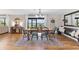 Open dining area featuring hardwood floors, a waterfront view, and modern decor at 16047 E Shirley Shores Rd, Tavares, FL 32778