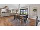 Chandelier illuminates dining room with table, chairs and sliding glass doors to backyard at 16047 E Shirley Shores Rd, Tavares, FL 32778